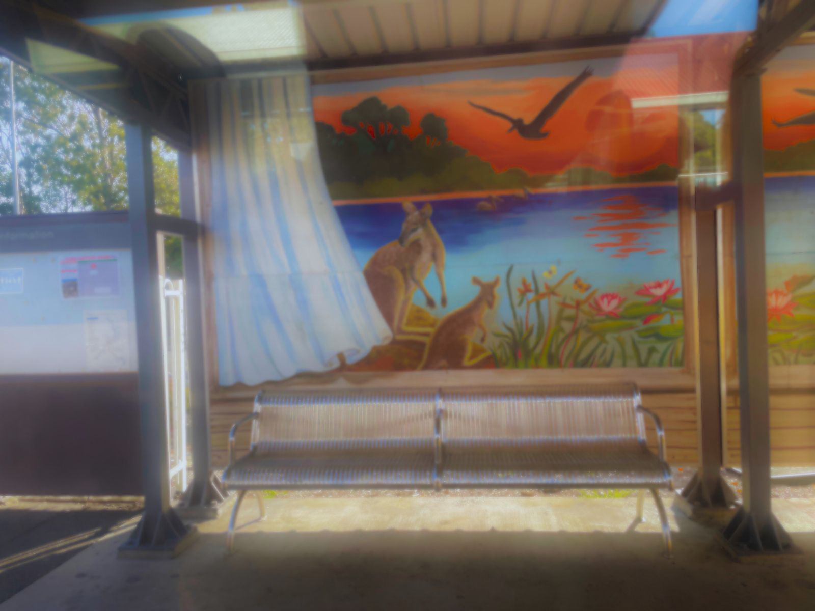 Loganlea station. Saw this pretty nice painting of kangaroos by the lake. Train almost full now. My stomach stopped grumbling.